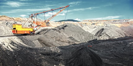 A yellow dragline operating in a quarry