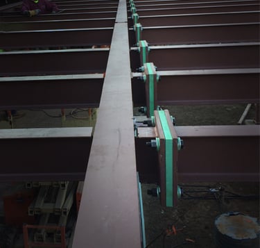 Thermal break material installed throughout several connection points on a structural steel frame