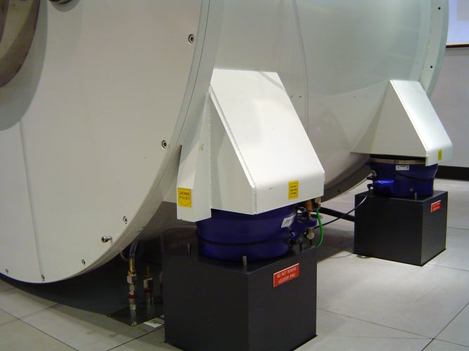 Two Fabreeka PAL Isolators installed underneath an MRI machine to reduce external vibration.